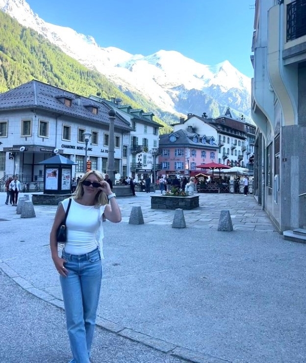 Grace Schlichter standing on a street in France