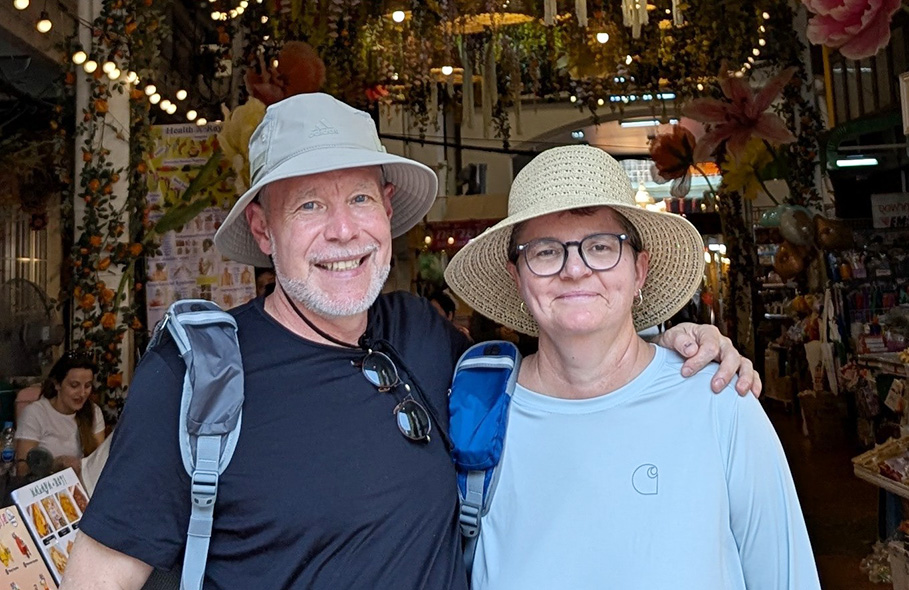 Chris and Wendy Harris smiling for a photo while on vacation.