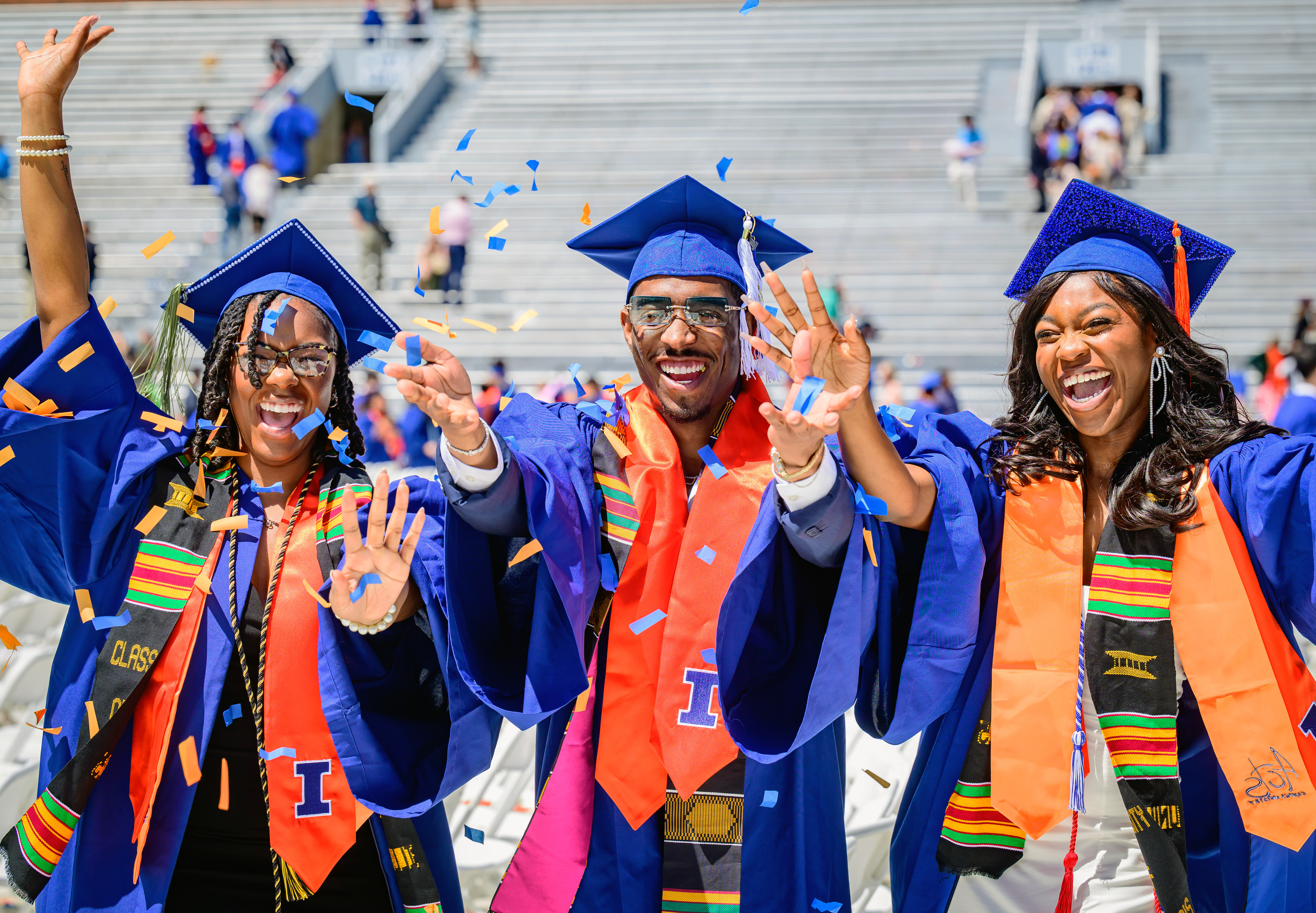 three university of Illinois graduate celebrate at Memorial Stadium