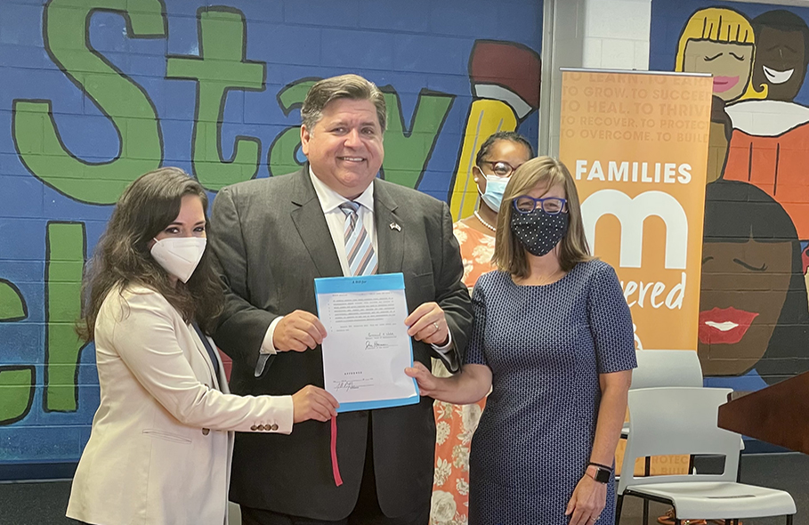 Alumna Cristina Pacione-Zayas and Governor JB Pritzker at HB2878 signing