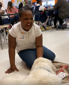 Ajax gets a treat from a student