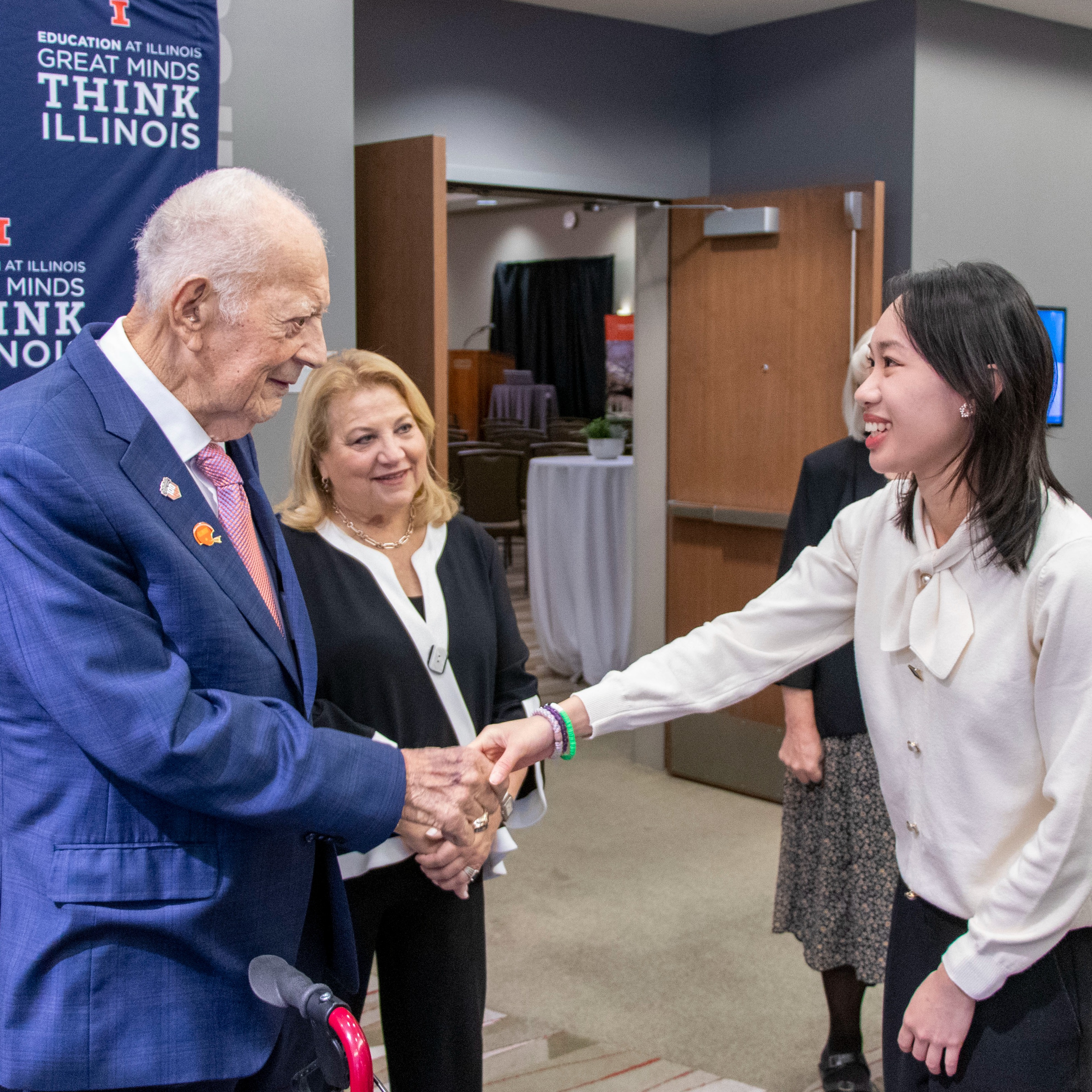 Phil Goldstick greets a doctoral fellow