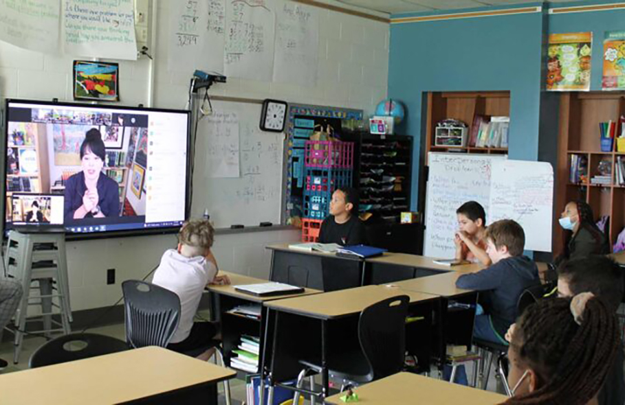 Kenwood Elementary students watch author on TV screen