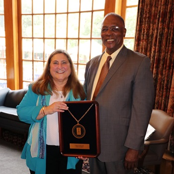 Lisa Monda-Amaya and James D. Anderson with the Dean's Medallion