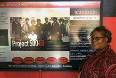 Roslyn Hunt stands next to a poster at Project 500 Gala