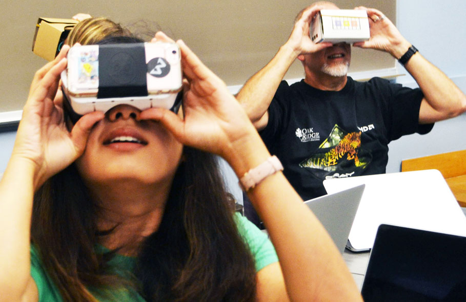 Students looking through virtual reality goggles