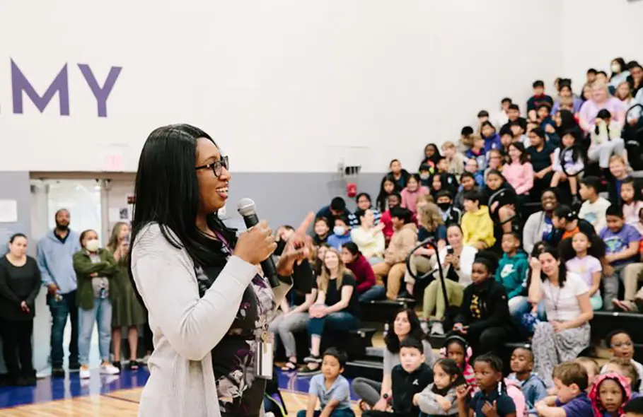 Teacher and alumna Kim Tate speaks to 500 students
