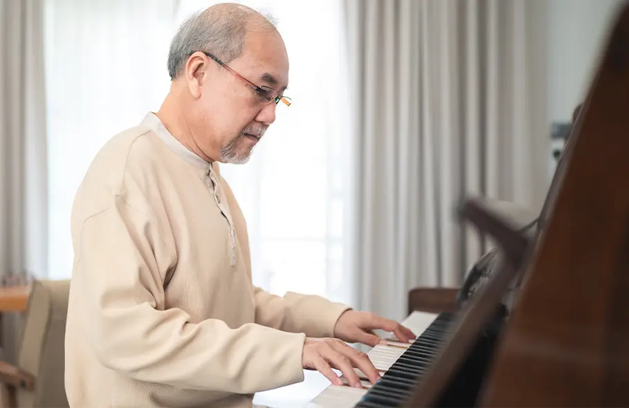 An older man playing the piano