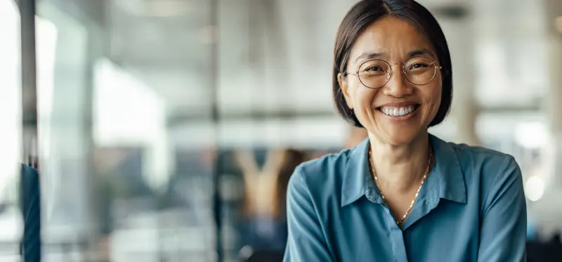 Female person with glasses smiling